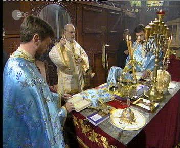 Bishop TICHON Incending the Offerings, Priest LYUBOMIR and Priest YULIAN praying at the Altar
